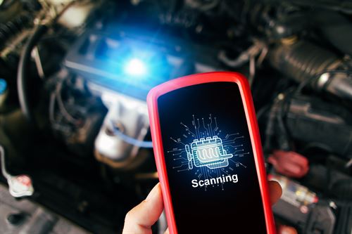 Systems Diagnostic with a tool scanning the car.